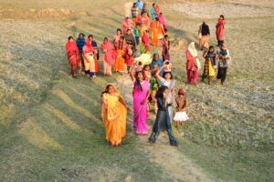 Photo by Sandeep Mahto: https://www.pexels.com/photo/high-angle-shot-of-a-group-of-women-in-traditional-dresses-walking-on-a-field-16916622/